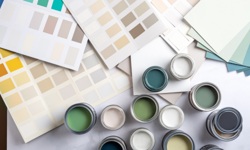 Various paint swatches and samples laid out across a table